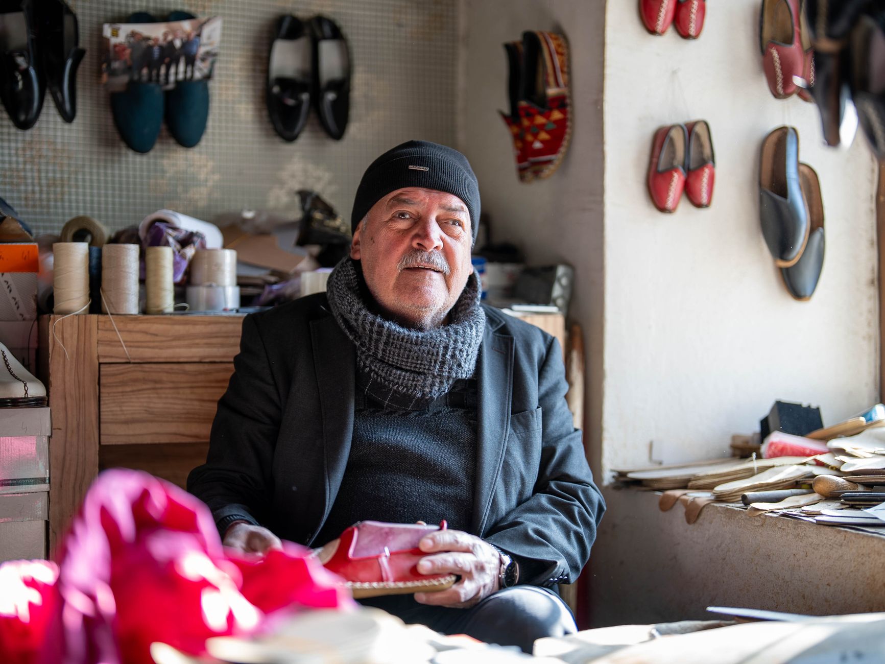 Handmade leather goods with whimsical designs displayed in a studio.